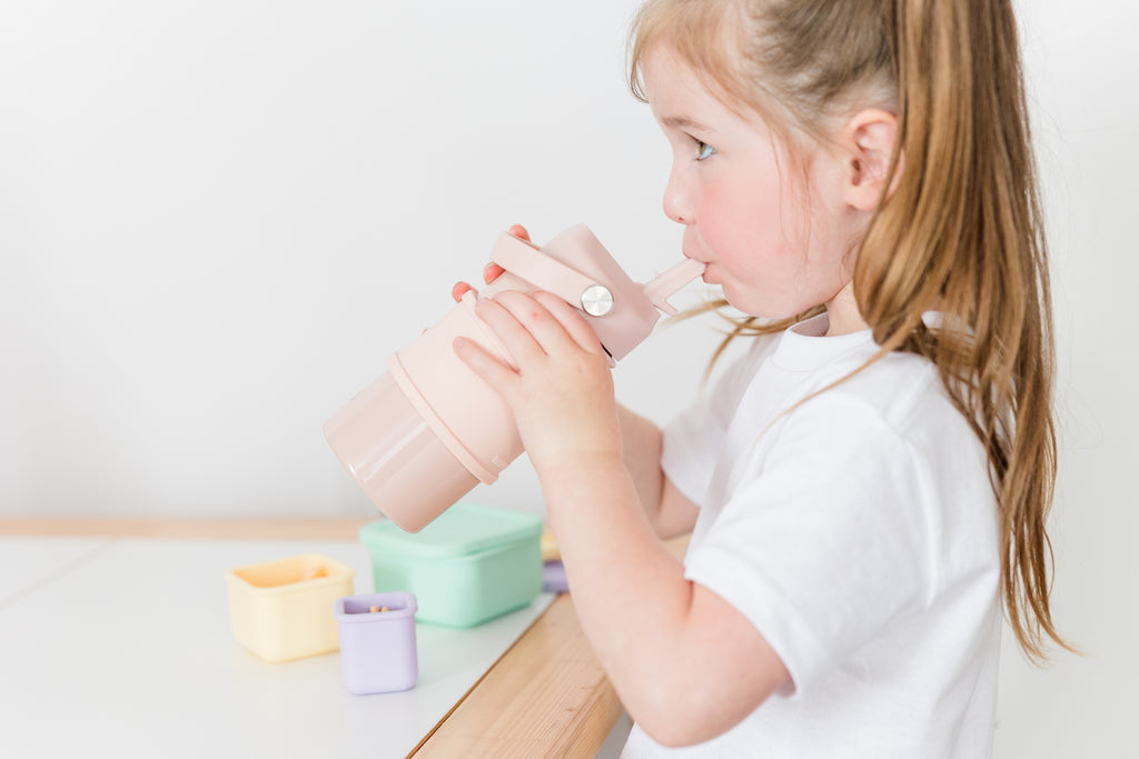 little girl drinking from a kids water bottle